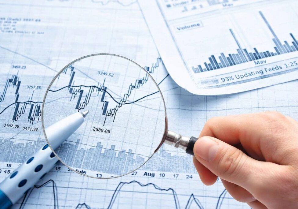a magnifying glass used on a graph chart with a pen